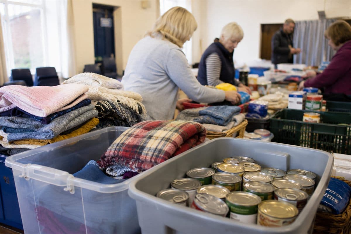 Collection buckets filled with donated clothing and tinned food.